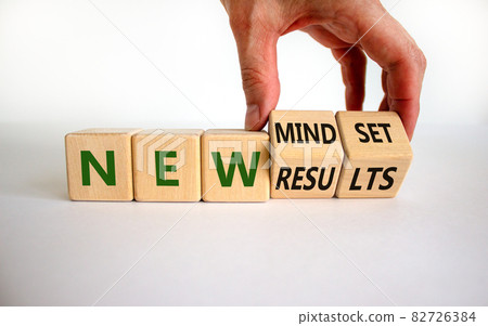 New mindset and results symbol. Businessman turns wooden cubes and changes words 'new mindset' to 'new results'. Beautiful white background. Business, new mindset and results concept. Copy space. New mindset and results symbol. Businessman turns wooden cubes and changes words 'new mindset' to 'new results'. Beautiful white background. Business, new mindset and results concept. Copy space. 82726384