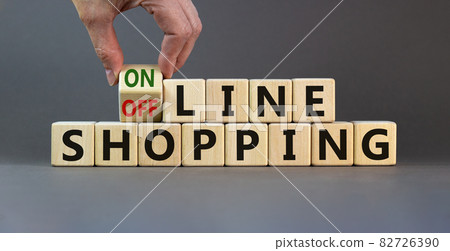 Time to online shopping. Male hand turns the cube and changes the expression 'offline shopping' to 'online shopping'. Beautiful grey background. Business concept. Copy space. Time to online shopping. Male hand turns the cube and changes the expression 'offline shopping' to 'online shopping'. Beautiful grey background. Business concept. Copy space. 82726390