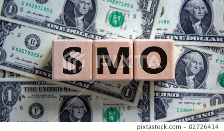 SMO, social media optimization symbol. Wooden cubes with word 'SMO, social media optimization' on beautiful background from dollar bills, copy space. Business, SMO - social media optimization concept. SMO, social media optimization symbol. Wooden cubes with word 'SMO, social media optimization' on beautiful background from dollar bills, copy space. Business, SMO - social media optimization concept. 82726414