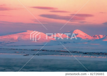 Winter aerial view of the coastline and mountains at sunset. 82726881
