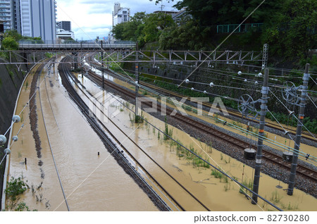 Railroad tracks flooded with muddy water 82730280