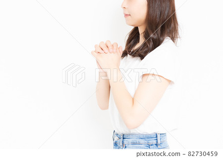Young woman in a T-shirt making a request gesture Young woman in a T-shirt making a request gesture 82730459