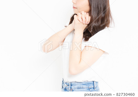 Young woman in a T-shirt making a request gesture Young woman in a T-shirt making a request gesture 82730460