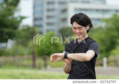 Young men exercising and using smart watches 82730797