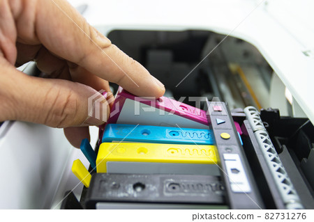 Technicians are install setup the ink cartridge of a inkjet printer the device of office automate for printing Technicians are install setup the ink cartridge of a inkjet printer the device of office automate for printing 82731276