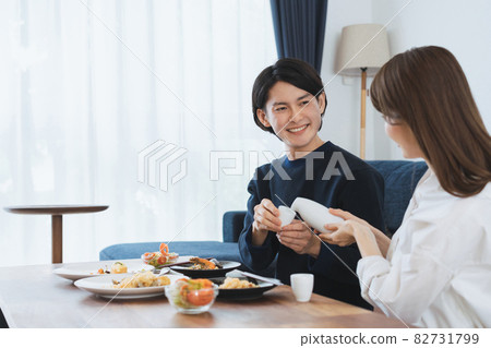 A couple enjoying a relaxing meal in the dining room A couple enjoying a relaxing meal in the dining room 82731799