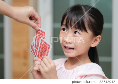 Girl playing cards to maid Girl playing cards to maid 82732042