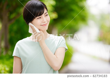 A young lady wiping a sweat with a handkerchief A young lady wiping a sweat with a handkerchief 82734183