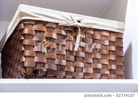 Organization of home space, order, cleanliness and comfort. Household goods storage equipment. Box baskets are woven fabric from trendy natural eco materials. Interior decor element 82734187