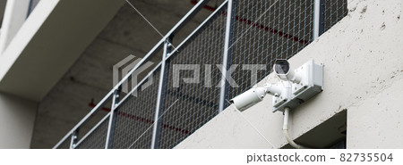 Security cameras on modern building. Professional surveillance camera. CCTV on the wall with LED IR lights. Security system, technology concept. Video equipment for safety system area control outdoor. 82735504