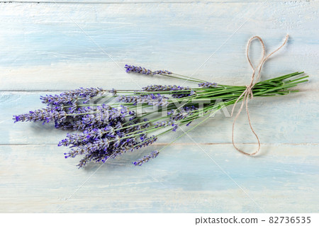 Lavender bouquet on a rustic wooden background, a bunch of lavandula plants Lavender bouquet on a rustic wooden background, a bunch of lavandula plants 82736535