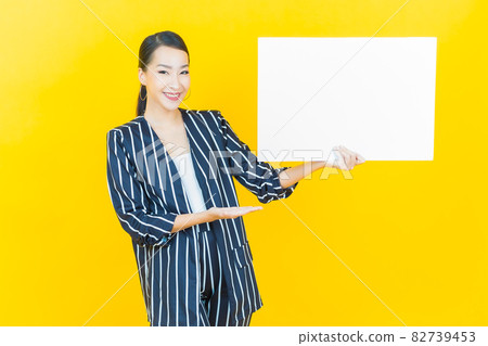Portrait beautiful young asian woman with empty white billboard Portrait beautiful young asian woman with empty white billboard 82739453