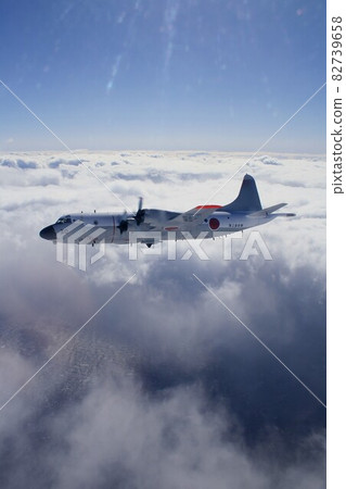 A P-3C Orion patrol aircraft that swirls under the sea of clouds that extends to the horizon. 82739658