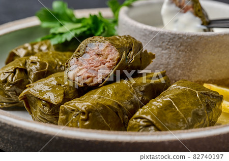 Macro piece of dolma, on the cut minced meat and rice 82740197