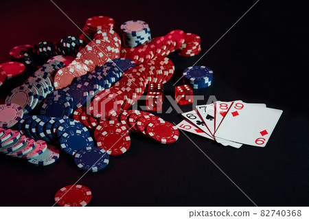 Casino chips and cards on black table surface. Gambling, fortune, game and entertainment concept - close up Casino chips and cards on black table surface. Gambling, fortune, game and entertainment concept - close up 82740368