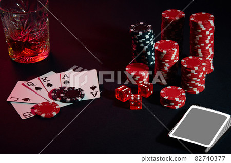 Cards of poker player. On the table are chips and a glass of cocktail with whiskey. Combination of cards - Royal Flush Cards of poker player. On the table are chips and a glass of cocktail with whiskey. Combination of cards - Royal Flush 82740377