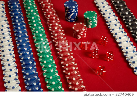 Stack of poker chips on red background at casino 82740409