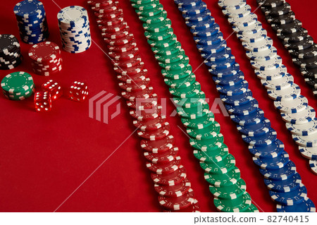 Stack of poker chips on red background at casino 82740415