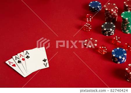 Poker cards and gambling chips on red background Poker cards and gambling chips on red background 82740424