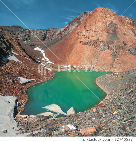 Bright alpine landscape with mountain lake in highland valley in sunlight. Mountaineering camp at the Blue Lake. Aktru. 82740582