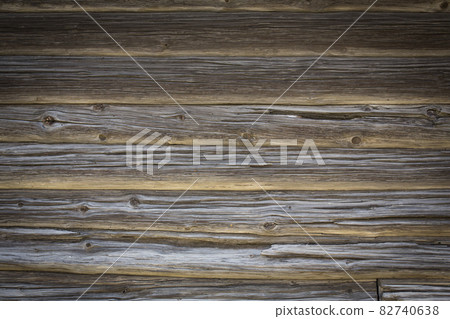 Wooden logs of an old house. Close-up. Weathered natural gray wood texture. Background. Horizontal photo Wooden logs of an old house. Close-up. Weathered natural gray wood texture. Background. Horizontal photo 82740638