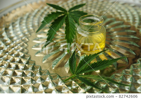 Marijuana oil, cbd recreation. Fresh cannabis leaf close up. Home relaxation, pastime therapy. 82742606
