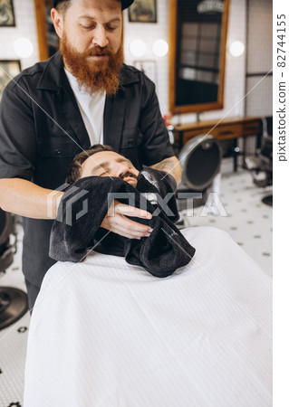 Professional barber, clipper preapring client for haircut, shaving at barbershop. Beauty, selfcare, style, fashion and male cosmetics concept. Professional barber, clipper preapring client for haircut, shaving at barbershop. Beauty, selfcare, style, fashion and male cosmetics concept. 82744155