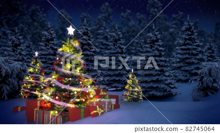 shiny Christmas tree before snow covered forest at night 82745064