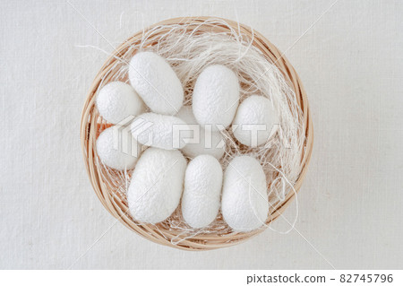 white silkworm cocoons shells, source of silk fabric in the basket white silkworm cocoons shells, source of silk fabric in the basket 82745796