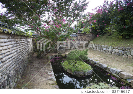 A small pond in a stone wall A small pond in a stone wall 82746627