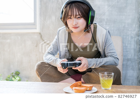 A woman playing a net game (online game) in the room 82746927