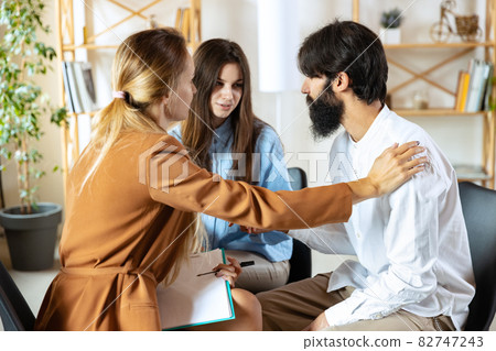 Session with family psychologist. Married couple, unhappy man and woman meeting with consultant to solve problem Session with family psychologist. Married couple, unhappy man and woman meeting with consultant to solve problem 82747243