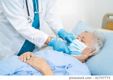 Doctor help Asian senior or elderly old lady woman patient wearing a face mask in hospital for protect safety infection and kill Covid-19 Coronavirus. Doctor help Asian senior or elderly old lady woman patient wearing a face mask in hospital for protect safety infection and kill Covid-19 Coronavirus. 82747773