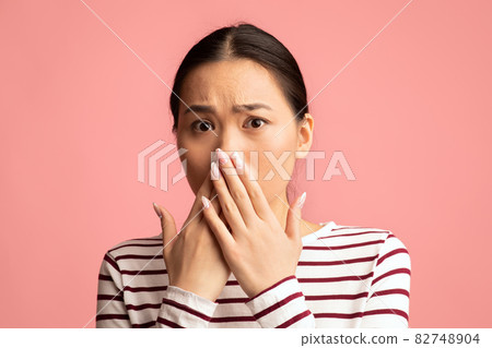 Oh No. Portrait Of Shocked Asian Woman Covering Mouth With Hands Oh No. Portrait Of Shocked Asian Woman Covering Mouth With Hands 82748904