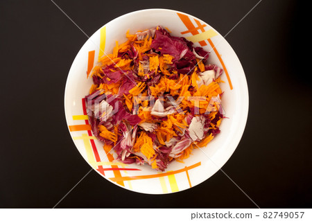 Salad with carrots on black table, top view 82749057