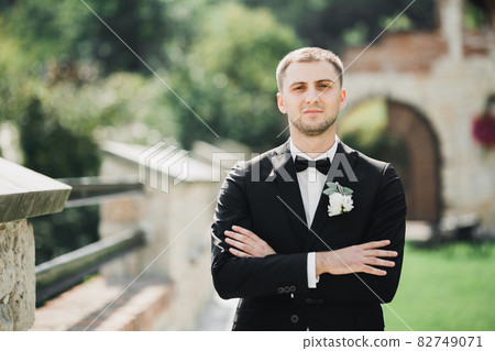 Headshot portrait of young man smiling isolated on outside outdoors background 82749071