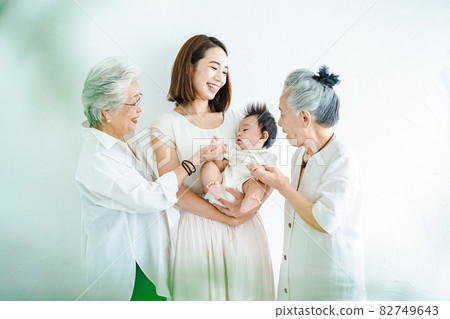 Mom holding a baby and two senior women Mom holding a baby and two senior women 82749643