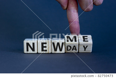 New me symbol. Hand turns cubes and changes words 'new day' to 'new me'. Beautiful grey background. Copy space. Business and new me concept. New me symbol. Hand turns cubes and changes words 'new day' to 'new me'. Beautiful grey background. Copy space. Business and new me concept. 82750473