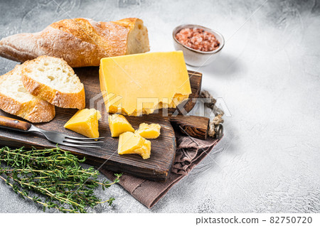 Gouda cheese with bread ready for cooking sandwich. White background. Top view. Copy space Gouda cheese with bread ready for cooking sandwich. White background. Top view. Copy space 82750720
