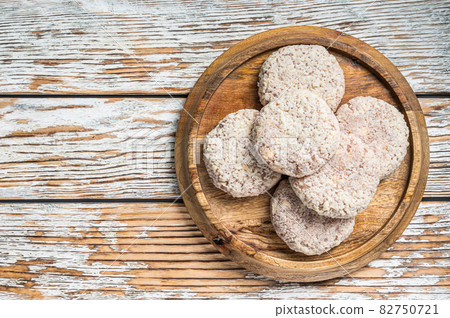 Raw chicken patty cutlet with breadcrumbs. White wooden background. Top view. Copy space Raw chicken patty cutlet with breadcrumbs. White wooden background. Top view. Copy space 82750721