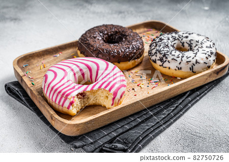 Donuts with chocolate, pink glazed and sprinkles Doughnut. White background. Top view Donuts with chocolate, pink glazed and sprinkles Doughnut. White background. Top view 82750726