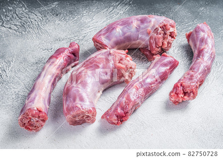 Raw Turkey neck meat on a butcher table. White background. Top View Raw Turkey neck meat on a butcher table. White background. Top View 82750728