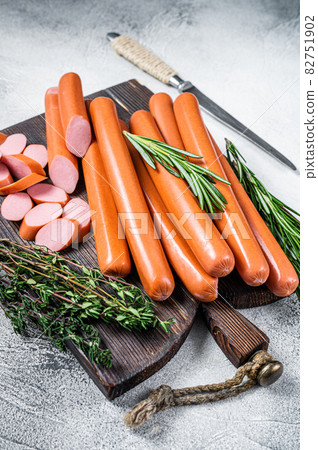 German raw Frankfurter sausages on a wooden board. White background. Top view German raw Frankfurter sausages on a wooden board. White background. Top view 82751902