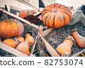 Bright orange Halloween pumpkins in a wooden crate 82753074