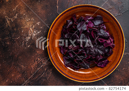 Raw Ruby or red chard salad Leafs on a rustic plate. Dark background. Top view. Copy space Raw Ruby or red chard salad Leafs on a rustic plate. Dark background. Top view. Copy space 82754174