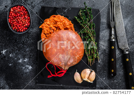 Balearic Sobrassada cured meat sausage from ground pork, paprika and spices. Black background. Top view Balearic Sobrassada cured meat sausage from ground pork, paprika and spices. Black background. Top view 82754177