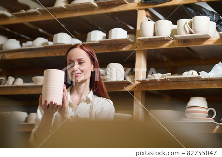 A cute young female potter in her workshop A cute young female potter in her workshop 82755047