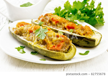 Cucumber stuffed with meat and vegetables on board Cucumber stuffed with meat and vegetables on board 82755678