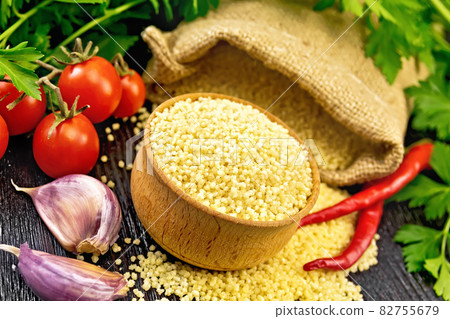 Couscous raw in bowl on wooden board Couscous raw in bowl on wooden board 82755679