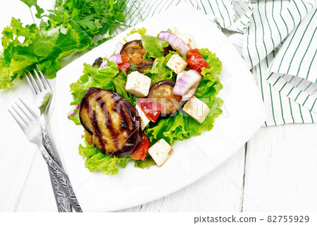 Salad of eggplant with cheese and tomatoes on white board 82755929